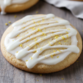 white glaze with lemon zest in it on a sugar cookie